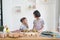 Two little girl cooks in the kitchen at home