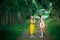 Two little girl friends gossip in a pine Park. Walk.