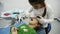 Two little girl play the roles of dentist during a dental check-up