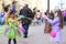 Two little girls blow a lot of soap bubbles in the street