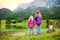 Two little girls enjoying the view of wonderful green waters of Hintersee lake. Amazing autumn landscape of Bavarian Alps on the A