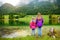 Two little girls enjoying the view of wonderful green waters of Hintersee lake. Amazing autumn landscape of Bavarian Alps on the A