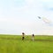 Two little girls fly a kite