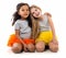 Two little girls-friends with different complexion sitting on the floor