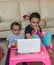 Two little girls with laptop at home