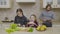 Two little girls learning to make a salad