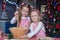 Two little girls make gingerbread cookies for