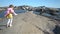 Two little girls play among the coastal rocks on the beach.