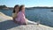 Two little girls play among the coastal rocks on the beach.