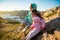 Two little girls play on rocky northern seashore.