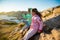 Two little girls play on rocky northern seashore.