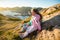 Two little girls play on rocky northern seashore.