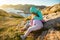 Two little girls play on rocky northern seashore.