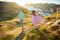 Two little girls play on rocky northern seashore.