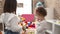 Two little girls playing with construction block pieces standing at kindergarten