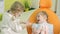 two little girls are playing in the dental office using dental instruments