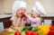 Two little girls preparing healthy food on kitchen