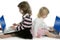 Two little girls sister with computer laptops