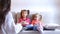 Two little girls sit on couch and cry