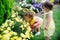 Two Little Girls Smelling Spring Flowers