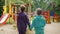 Two little girls standing near closed playground during coronavirus pandemic