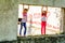 Two little girls standing on the old window opening