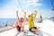 Two little kid boys, best friends enjoying sailing boat trip. Family vacations on ocean or sea on sunny day. Children