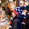 Two little kid boys selecting decoration on Christmas market. Beautiful siblings and best friends shopping for toys and