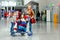 Two little kids, boy and girl, siblings and mother at the airport. Children, family traveling, going on vacation by