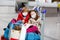 Two little kids, boy and girl wearing medical masks at the airport. Happy children, family travel together, going on