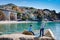 Two little kids boys climbing on stones on beach of Mediterranean sea in Liguria region, Italy. Siblings brothers in