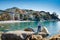 Two little kids boys climbing on stones on beach of Mediterranean sea in Liguria region, Italy. Siblings brothers in