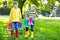 Two little kids boys, cute siblings with lots of colorful rain boots. Children in different rubber boots and jackets