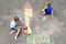 Two little kids boys drawing knight castle with colorful chalks on asphalt. Happy siblings and friends having fun with