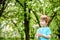 Two little kids boys and friends in Easter bunny ears during traditional egg hunt in spring garden, outdoors. Siblings having fun