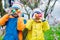 Two little kids boys and friends making traditional Easter egg hunt