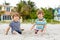 Two little kids boys having fun on tropical beach