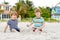 Two little kids boys having fun on tropical beach