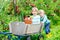 Two little kids boys picking red apples on farm autumn