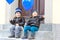 Two little kids boys playing with blue air balloons outdoors. Happy twins and toddler brothers smiling and laughing