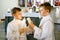 Two little kids boys receiving his first holy communion. Happy children holding Christening candle. Tradition in
