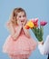 Two little kids. little girl receives flowers