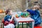 Two little kids painting with colors on pumpkin