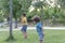 Two little kids playing with cardboard toy airplane in the park at the day time. Concept of happy game. Child having fun