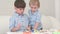 Two little kids playing with dough and learning how to bake