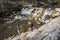 Two little kids playing next to a river in Palencia, Spain, during the winter ending and the spring beginning in a warm sunny day