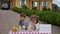 Two little kids are selling lemonade at a homemade lemonade stand on a sunny day with a price sign for an entrepreneur