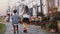 Two little kids walk together along old buildings. Girl and boy explore beautiful German old town. Togetherness and love