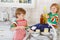 Two little lovely and funny kid boys washing dishes in domestic