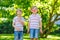 Two little preschool kid boys eating watermelon in summer